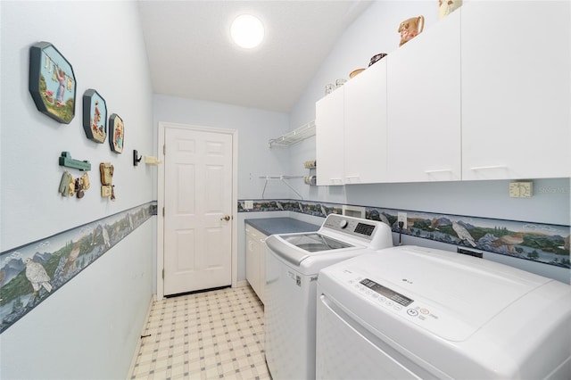 laundry room with cabinets, a textured ceiling, and separate washer and dryer