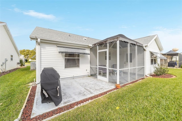 back of house with a sunroom, a patio area, and a yard