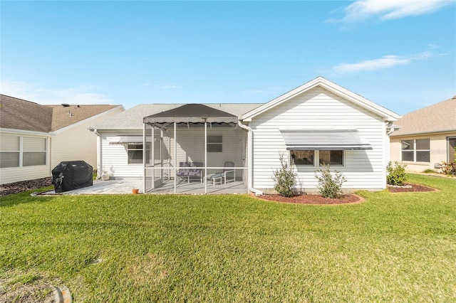 rear view of property with a yard and a patio