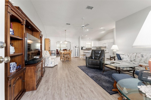 1904 De Hoyos Pl, The Villages, FL 32159 - living area with light wood-style floors, high vaulted ceiling, visible vents, and ceiling fan