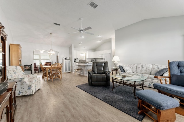 1904 De Hoyos Pl, The Villages, FL 32159 - living area with visible vents, ceiling fan, light wood-type flooring, and high vaulted ceiling