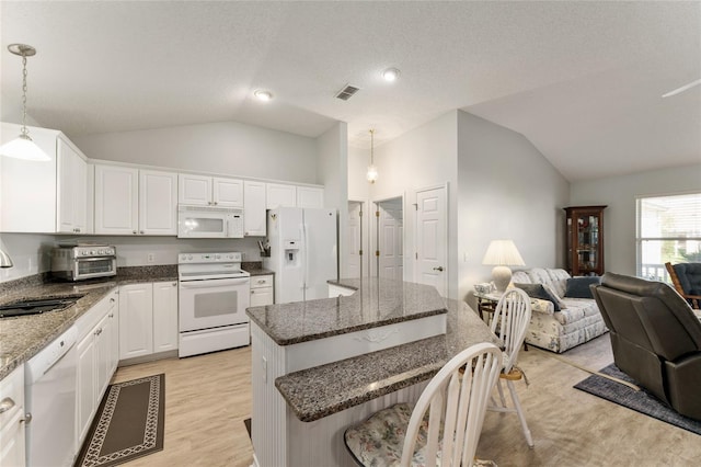 1904 De Hoyos Pl, The Villages, FL 32159 - kitchen with visible vents, a sink, open floor plan, a kitchen breakfast bar, and white appliances