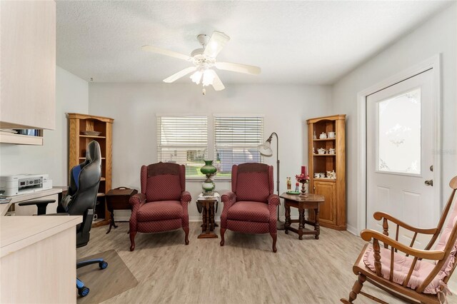 1904 De Hoyos Pl, The Villages, FL 32159 - home office with light wood-style floors, a textured ceiling, baseboards, and ceiling fan
