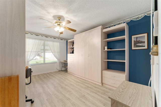 1904 De Hoyos Pl, The Villages, FL 32159 - unfurnished bedroom with light wood-type flooring, a textured ceiling, and ceiling fan