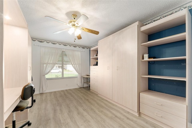 1904 De Hoyos Pl, The Villages, FL 32159 - unfurnished bedroom with ceiling fan, baseboards, light wood-style floors, and a textured ceiling