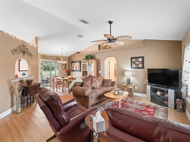 living room featuring light hardwood / wood-style floors, ceiling fan, and vaulted ceiling