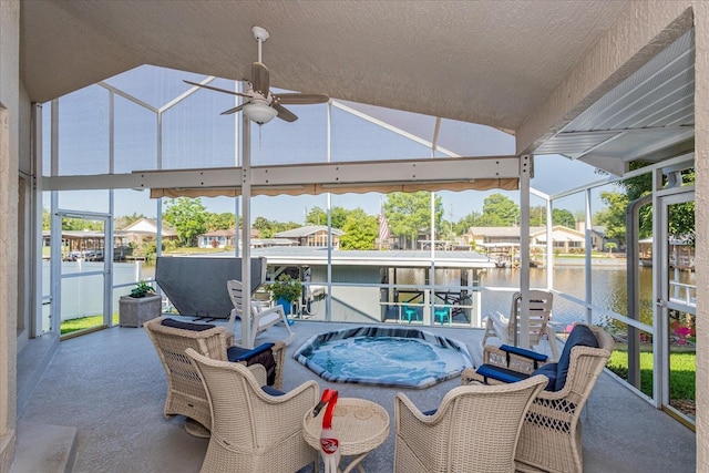 view of patio featuring a water view and ceiling fan