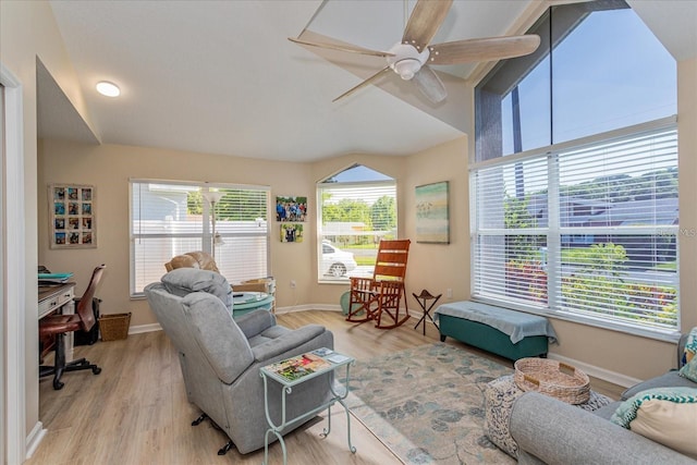 living room featuring vaulted ceiling, light hardwood / wood-style floors, and ceiling fan