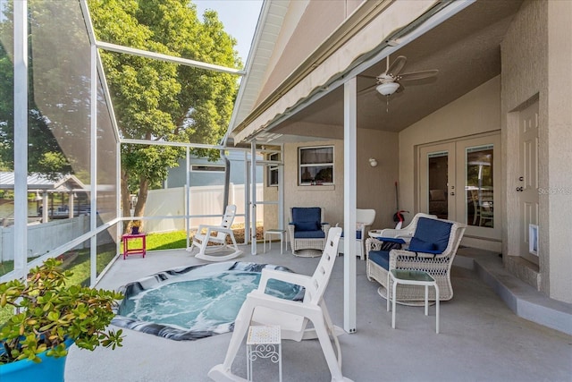 exterior space with a hot tub, lofted ceiling, ceiling fan, and french doors