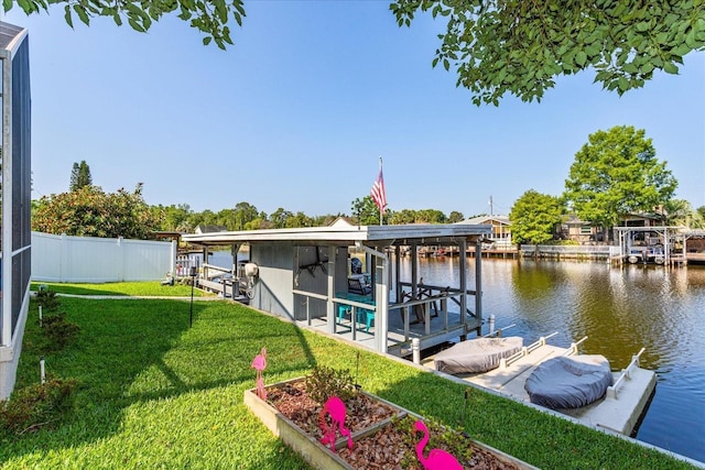 view of dock featuring a water view and a yard