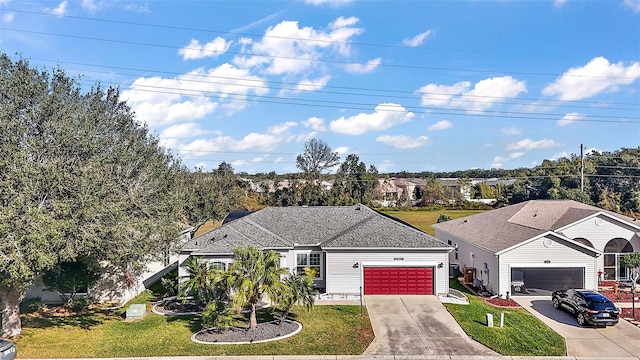 view of front of property featuring a garage and a front yard