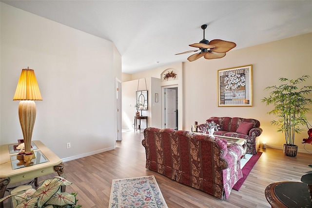 living room with ceiling fan and light hardwood / wood-style flooring