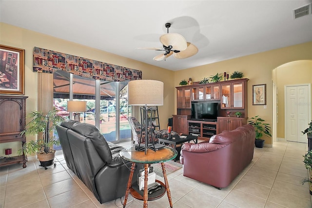 tiled living room featuring ceiling fan