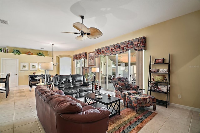 living room featuring ceiling fan and light tile patterned floors