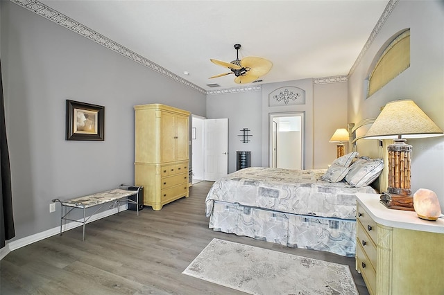 bedroom with ceiling fan and wood-type flooring