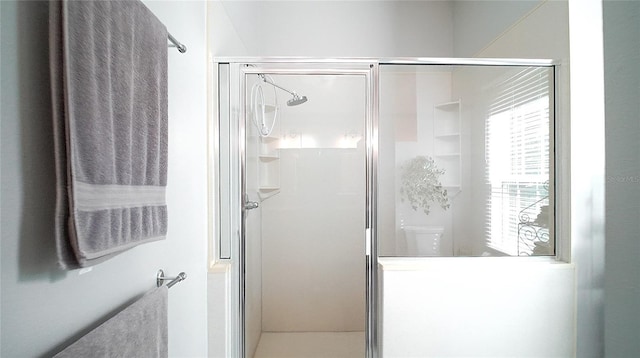 bathroom with a shower with door