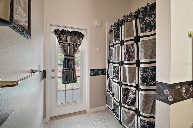 doorway to outside featuring light tile patterned flooring