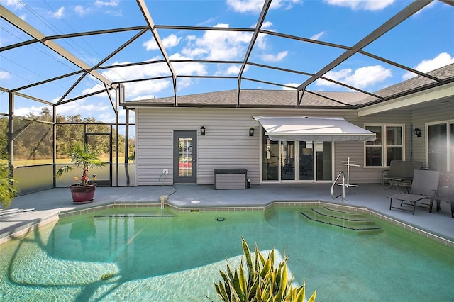 view of swimming pool featuring a patio and glass enclosure