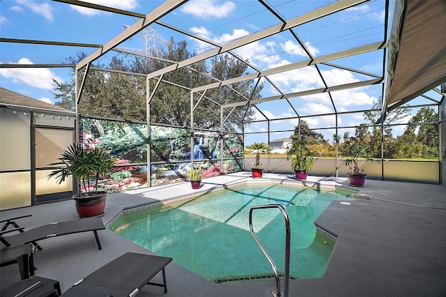 view of swimming pool with glass enclosure and a patio