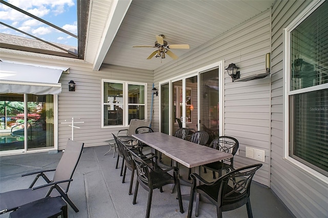 view of patio / terrace with ceiling fan and a lanai