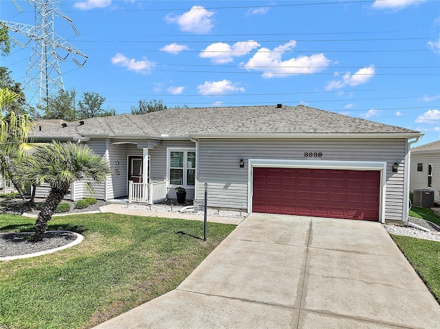 3839 Manor Oaks Ct, Leesburg, FL 34748 - ranch-style house featuring central AC, a shingled roof, a garage, a front lawn, and driveway