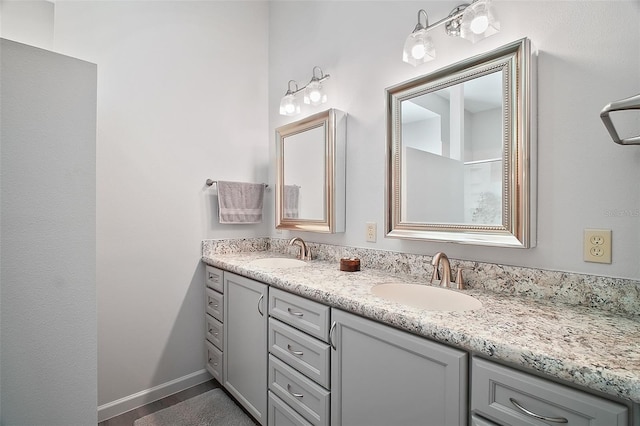 3839 Manor Oaks Ct, Leesburg, FL 34748 - full bath with double vanity, a sink, and baseboards