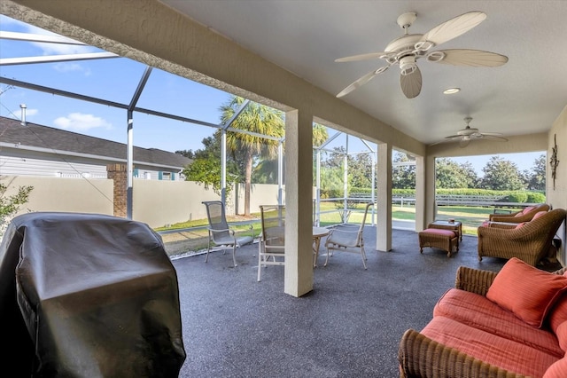 sunroom / solarium featuring plenty of natural light and ceiling fan