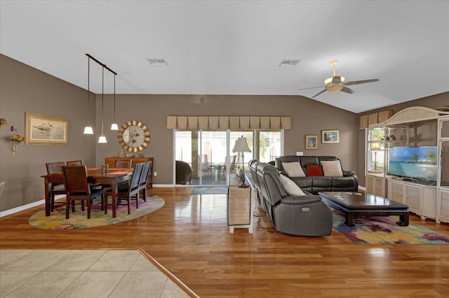 living room featuring plenty of natural light, ceiling fan, light hardwood / wood-style floors, and vaulted ceiling