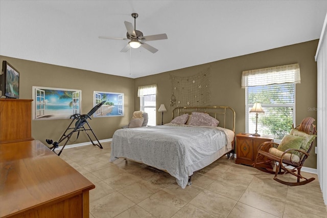 bedroom featuring ceiling fan and multiple windows