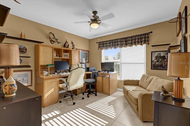 tiled office featuring ceiling fan and a textured ceiling