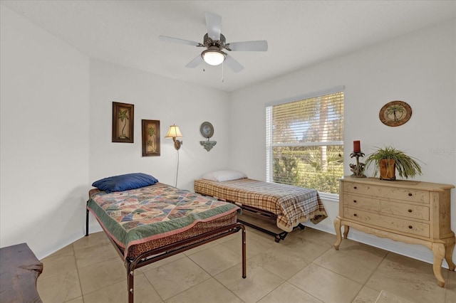 tiled bedroom featuring ceiling fan