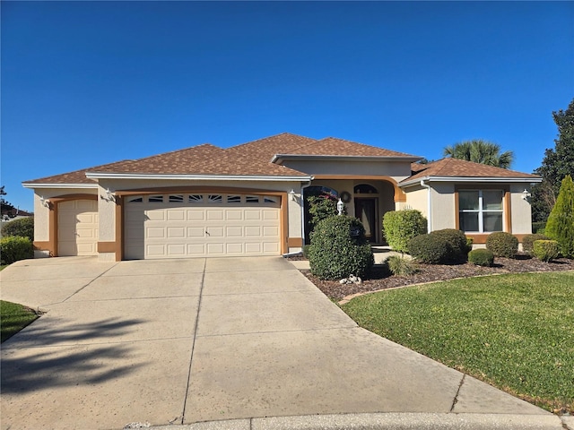 view of front of home featuring a front yard and a garage