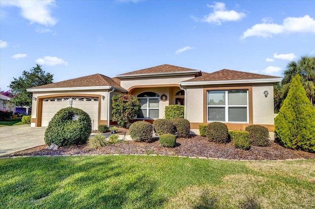 view of front of house with a garage and a front lawn