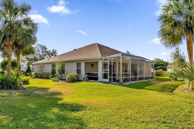 rear view of property with a lanai and a lawn