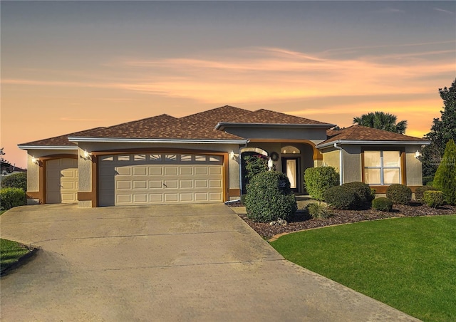 view of front of house featuring a yard and a garage