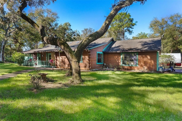 rear view of property with a lawn