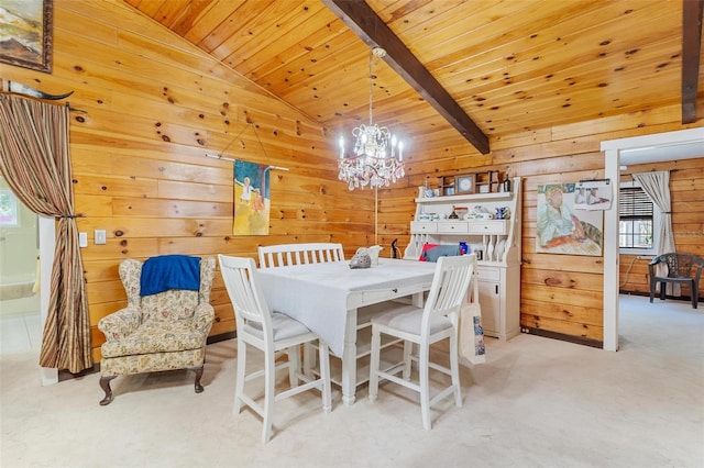 carpeted dining room featuring beamed ceiling, a notable chandelier, wood walls, and wood ceiling