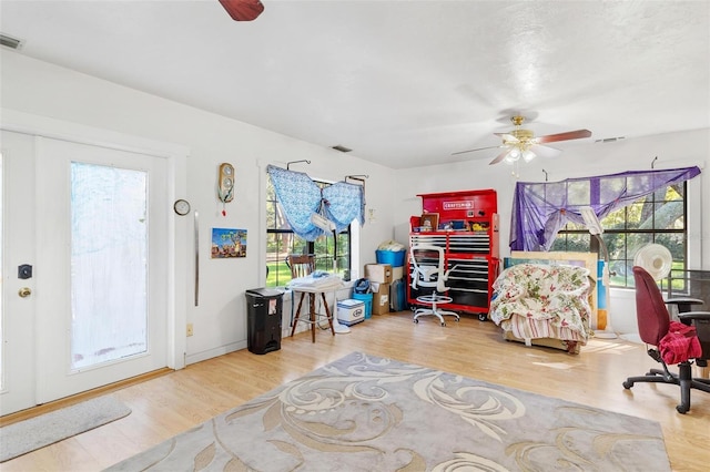 interior space with ceiling fan and hardwood / wood-style flooring