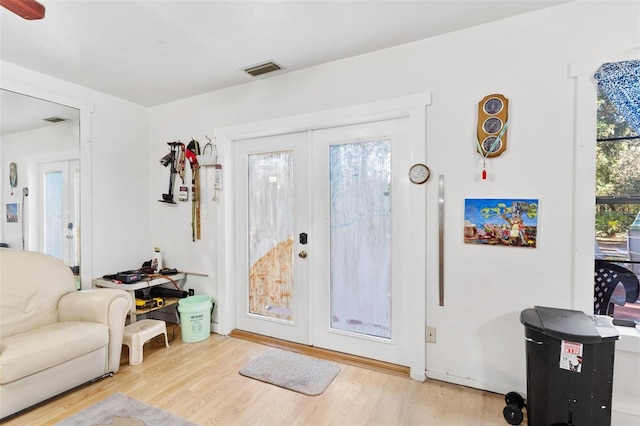 entryway with wood-type flooring and french doors