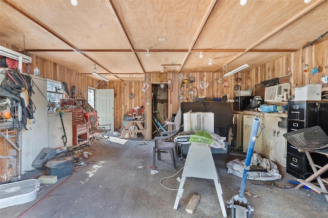 miscellaneous room with concrete flooring and a workshop area