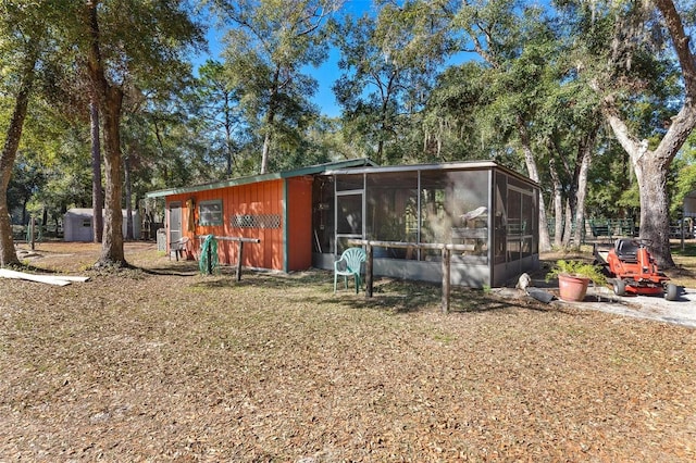 view of front of home featuring a shed