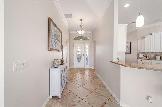 entrance foyer with ornamental molding, visible vents, baseboards, and light tile patterned floors