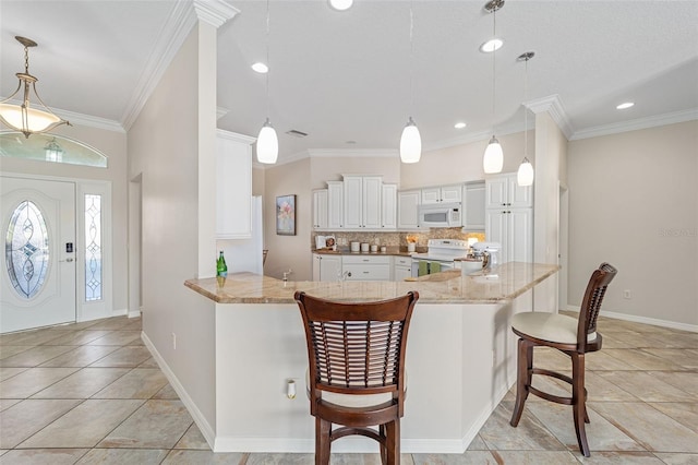 kitchen featuring light stone counters, a peninsula, white appliances, tasteful backsplash, and crown molding