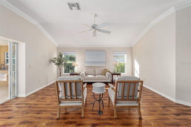 living room featuring baseboards, visible vents, wood finished floors, and ornamental molding