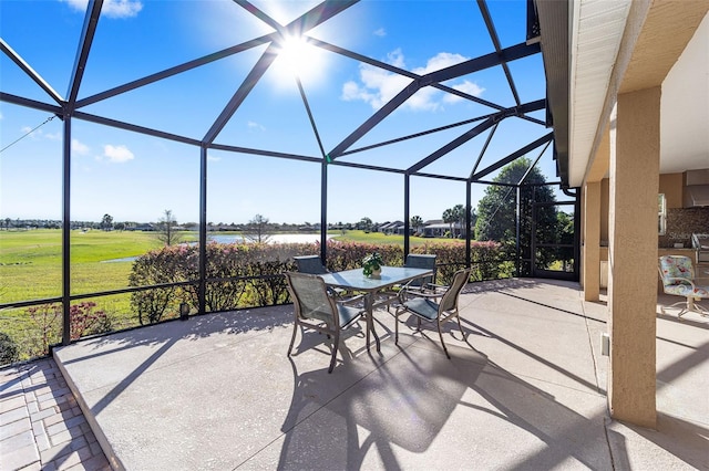 view of patio with outdoor dining space and a lanai