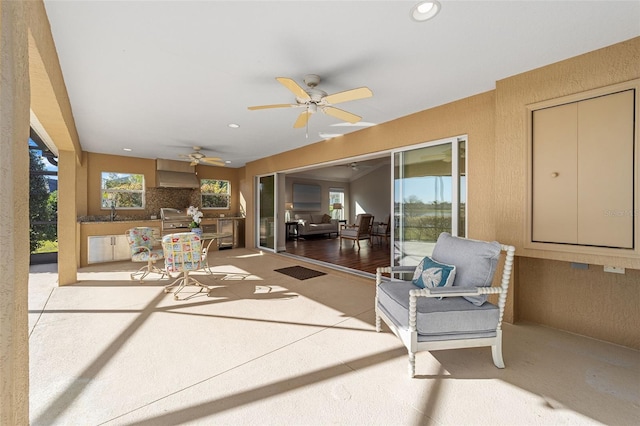 view of patio / terrace with a sink, ceiling fan, and exterior kitchen