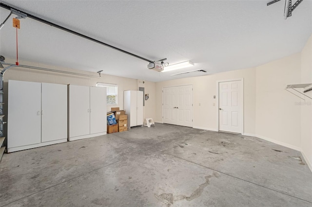 garage with a garage door opener and baseboards