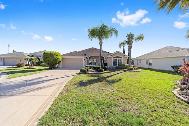 view of front of house featuring a garage, driveway, a front yard, and stucco siding