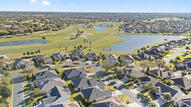 birds eye view of property featuring golf course view, a water view, and a residential view