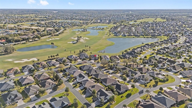 bird's eye view with a water view, view of golf course, and a residential view